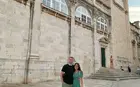 two people outside a historic building in Europe