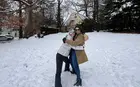 Two people hugging on a snowy hill. 