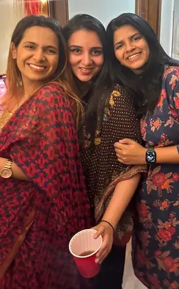 Three people smiling at a Diwali celebration