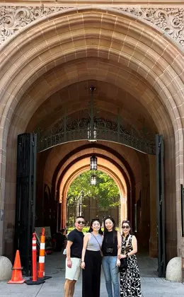 A group of people posing in front of Yale University's Phelps Gate