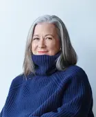 Headshot of Colleen DeCourcy in a blue turtleneck sweater