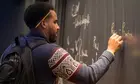 A student works a problem at the board