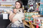woman shopping for pet food with dog