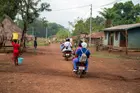 Nurses on motorcycles in a rural village in Sierra Leone