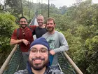 A group of students hiking over a bridge