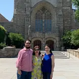 group of three people outside Yale building