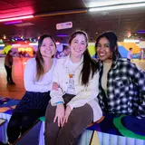 Three students at a roller rink