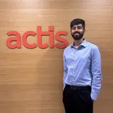 Craig Miranda in front of Actis sign