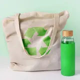 reusable shopping bag with recycling symbol and reusable water bottle