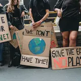 people holding climate change communication signs