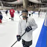 Megan Grossman in hockey uniform on the ice