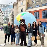group of people with a person dressed as a bear