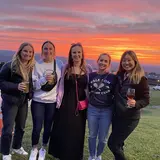 5 students in front of a sunset