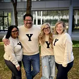 Jenifer Chon and 3 friends wearing white sweaters with the Yale Y logo on them.