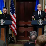 President Zelensky and President Biden standing at lecterns talking