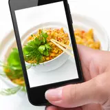 person taking a picture of their food