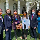 Group of people outside the White House wearing masks