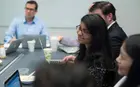 Participants gathered around a table, working as a team