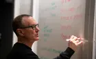 Professor James Baron writing on a whiteboard while teaching an Exec Ed program