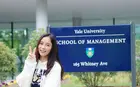 Fang Liu in front of Yale SOM Sign
