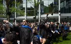 Students throwing their mortar boards in the air