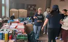 people in a room organizing donated goods