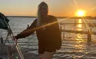 Trisha Farmer stepping onto a boat