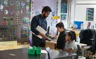 Student working with young people in a classroom