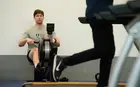 Student exercising on rowing machine