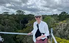 person on a deck atop a rainforest
