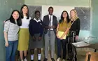 A group of MBA students posing with Kenyan students