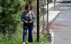 A person walking a dog outside