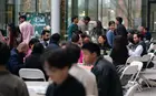 Students sit at tables in the Shen Courtyard at Evans Hall