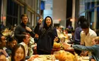 Students pose during a Thanksgiving dinner hosted at SOM