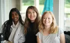 A group of three students smiling