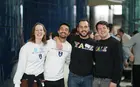 A group of four students wearing Yale apparel and smiling