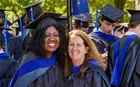 Sherilyn Scully, Yale SOM dean of students, posing with a student at Commencement
