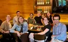 A group of people sitting around a table at a restaurant