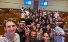 Several people posing for a selfie in a classroom