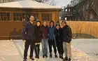 Several people posing in a snowy driveway