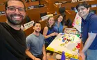 Several people working on a puzzle in a classroom