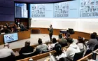 A person giving a presentation in an auditorium