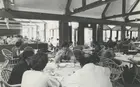 A black and white photo of students eating lunch in a university cafeteria