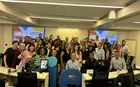 A group of students posing for a photo inside a classroom