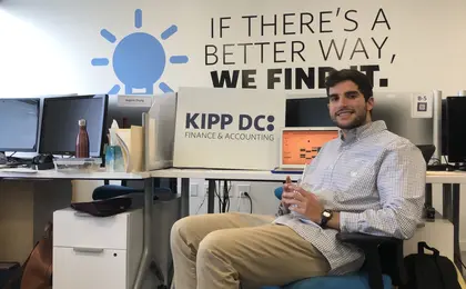 Laurence sitting at desk in KIPP DC office