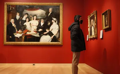 A museumgoer looking at art