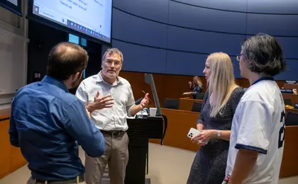 Professor Pinker and students conversing in a classroom