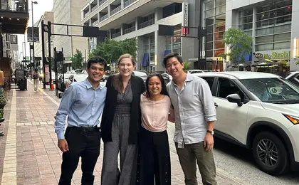 Several Yale SOM interns posing outside an office building on a city street