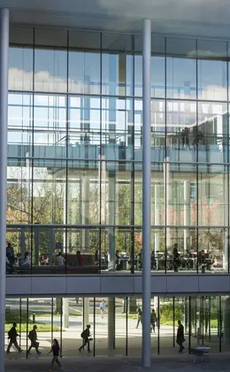 A view of people in Evans Hall seen through its immense windows