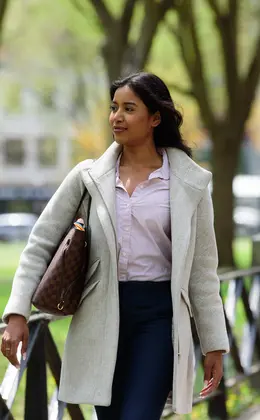 Woman walking next to the Green